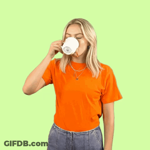 A Woman Is Holding A Cup Of Coffee And Making A Funny Face . GIF