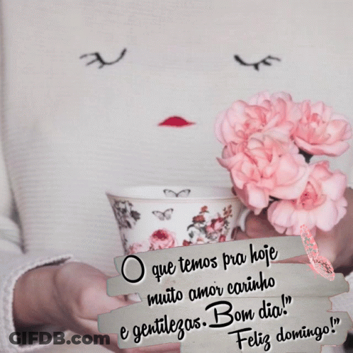A Woman Is Holding A Cup Of Coffee With Pink Flowers In Her Hands GIF
