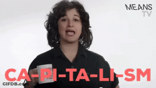 A Woman Is Holding A Cup With The Words Ca-Pi-Ta-Li-Sm Written On It GIF