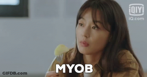 A Woman Is Holding A Fork And Eating A Piece Of Food . GIF