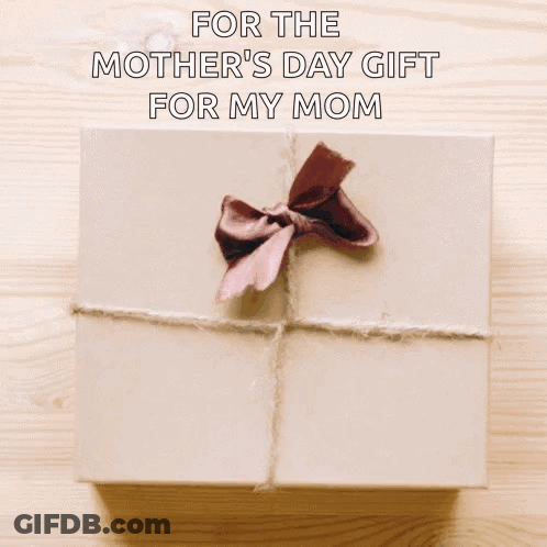 A Woman Is Holding A Gift Box With A Brown Bow On It . GIF