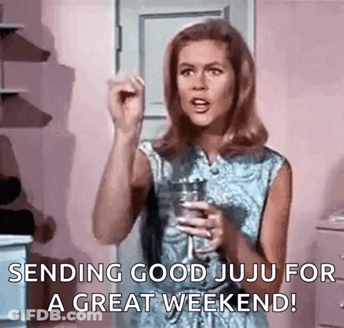 A Woman Is Holding A Glass Of Wine And Making A Funny Face . GIF