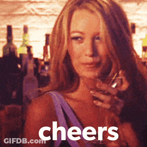 A Woman Is Holding A Glass Of Wine And The Word Cheers Is On The Bottom GIF