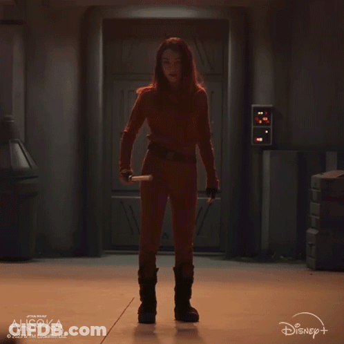 A Woman Is Holding A Green Lightsaber In Front Of A Disney Logo GIF