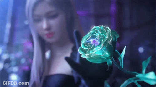 A Woman Is Holding A Green Rose In Her Hands . GIF