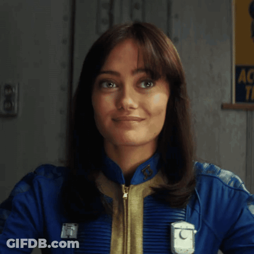 A Woman Is Holding A Gun In Front Of A Sign That Says Ac Tf GIF