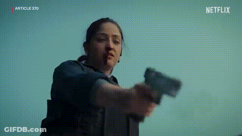 A Woman Is Holding A Gun In Her Hand In A Netflix Trailer . GIF