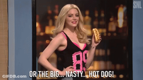 A Woman Is Holding A Hot Dog And Says Or The Big Nasty Hot Dog GIF