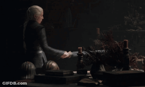 A Woman Is Holding A Large Sword In Her Right Hand GIF