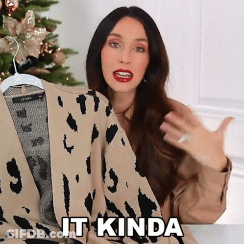 A Woman Is Holding A Leopard Print Sweater And Saying It Kinda GIF