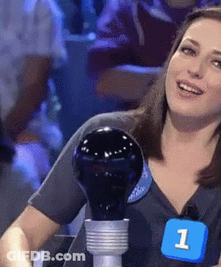 A Woman Is Holding A Light Bulb And Wearing A Number 1 Badge GIF