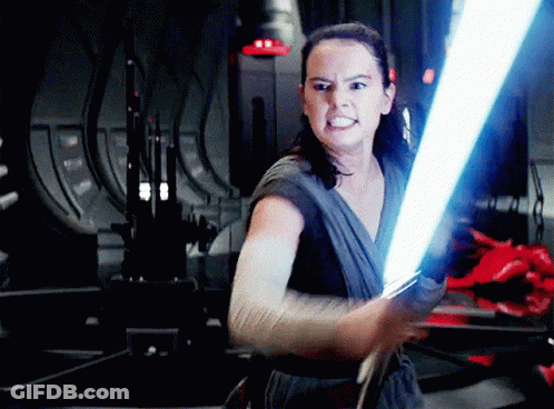 A Woman Is Holding A Light Saber In Her Right Hand GIF