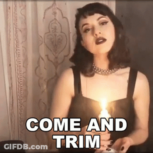 A Woman Is Holding A Lit Candle With The Words Come And Trim Written Above Her GIF