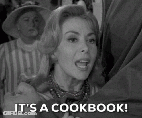 A Woman Is Holding A Man 'S Hand And Says `` It 'S A Cookbook '' . GIF