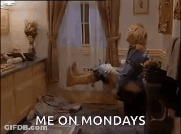 A Woman Is Holding A Man 'S Leg In Her Arms In A Living Room . GIF