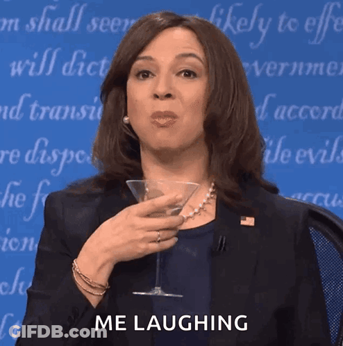 A Woman Is Holding A Martini Glass And Laughing GIF