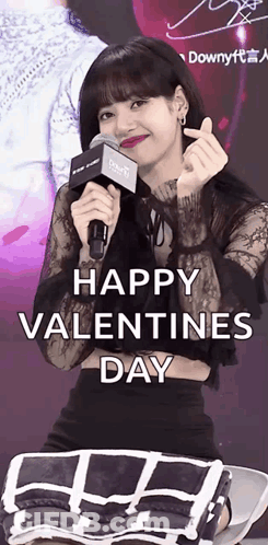 A Woman Is Holding A Microphone And Making A Heart Shape With Her Hands GIF