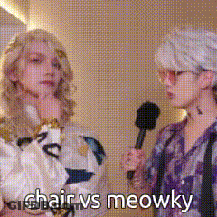 A Woman Is Holding A Microphone And Talking To Another Woman Who Is Holding A Microphone . GIF