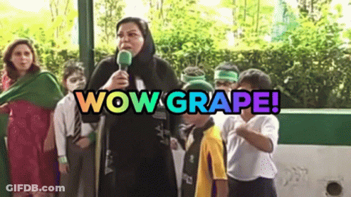 A Woman Is Holding A Microphone In Front Of A Group Of Children And The Words Wow Grape Are Above Her GIF