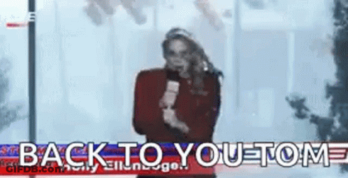 A Woman Is Holding A Microphone In Front Of A Sign That Says Back To You . GIF