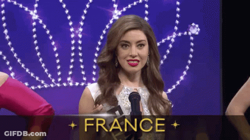 A Woman Is Holding A Microphone In Front Of A Sign That Says " France " GIF