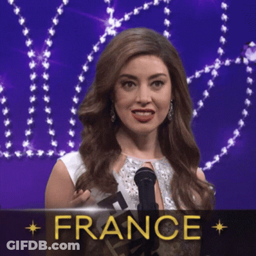 A Woman Is Holding A Microphone In Front Of A Sign That Says " France " GIF