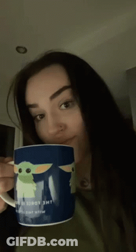 A Woman Is Holding A Mug That Says The Child GIF