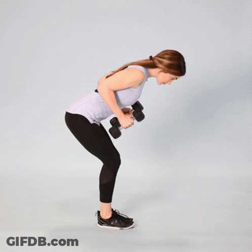 A Woman Is Holding A Pair Of Dumbbells While Bending Over GIF