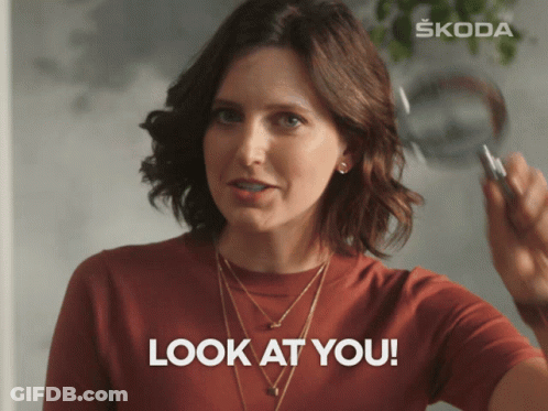 A Woman Is Holding A Pen In Her Hand And Says Look At You GIF