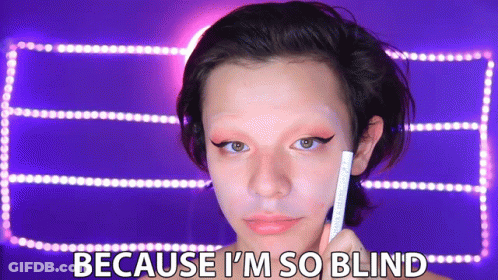 A Woman Is Holding A Pencil In Front Of Her Face With The Words Because I 'M So Blind Below Her GIF