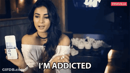 A Woman Is Holding A Phone And Says I 'M Addicted GIF