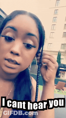 A Woman Is Holding A Phone With The Words I Cant Hear You On The Bottom GIF
