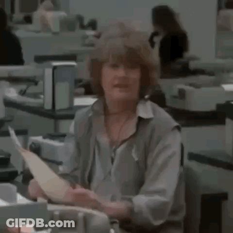 A Woman Is Holding A Piece Of Paper And Saying Atta Girl GIF