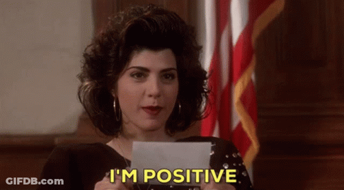 A Woman Is Holding A Piece Of Paper And Says I 'M Positive GIF