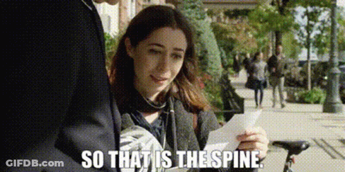 A Woman Is Holding A Piece Of Paper In Her Hand While Standing Next To A Man On A Sidewalk . GIF