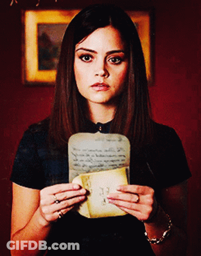 A Woman Is Holding A Piece Of Paper With The Number 33 Written On It GIF