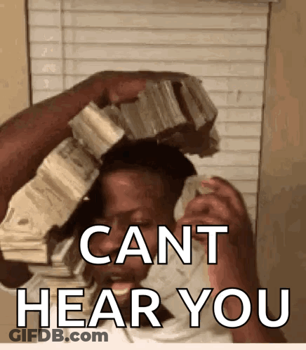 A Woman Is Holding A Pile Of Money Over Her Head And Says Cant Hear You GIF