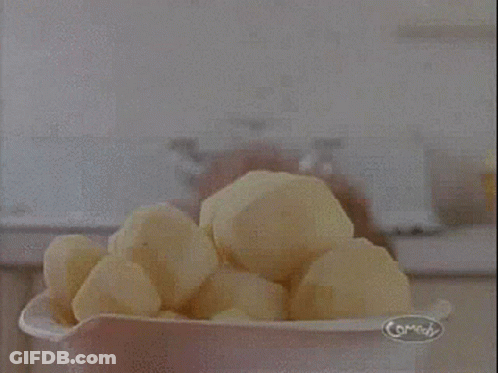 A Woman Is Holding A Pile Of Potatoes And Says Potatoes ! GIF