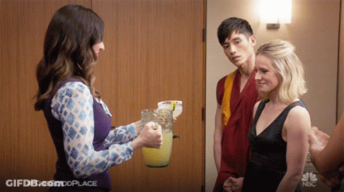 A Woman Is Holding A Pitcher Of Lemonade In Front Of A Man And A Woman With #Thegoodplace Written In The Corner GIF