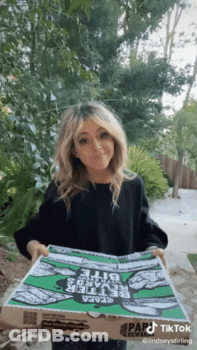A Woman Is Holding A Pizza Box That Says Papa John 'S On It GIF