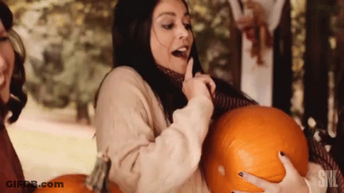 A Woman Is Holding A Pumpkin With The Word Snl On The Bottom GIF