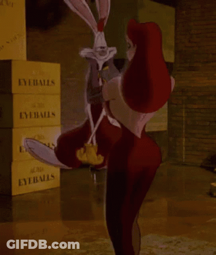 A Woman Is Holding A Rabbit In Front Of A Stack Of Eyeballs Boxes GIF