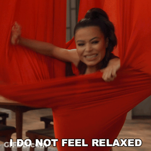 A Woman Is Holding A Red Cloth With The Words " I Do Not Feel Relaxed " Next To Her GIF