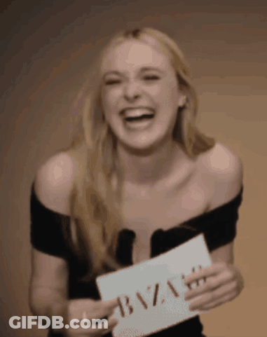 A Woman Is Holding A Sign That Says Bazaar GIF