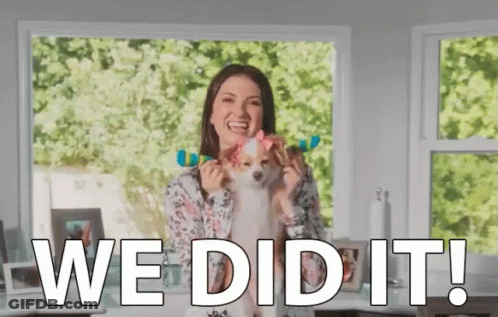 A Woman Is Holding A Small Dog With A Bow On Its Head And Says We Did It ! GIF