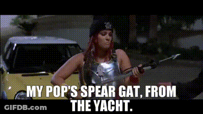 A Woman Is Holding A Spear In Front Of A Yellow Car . GIF