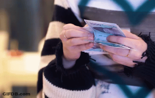 A Woman Is Holding A Stack Of 1000 Bills GIF