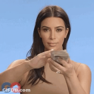 A Woman Is Holding A Stack Of Money In Her Hands And Eating It . GIF