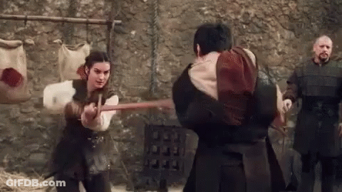 A Woman Is Holding A Sword And A Man Is Holding A Sword . GIF