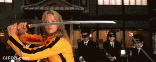 A Woman Is Holding A Sword In Front Of A Group Of Men GIF